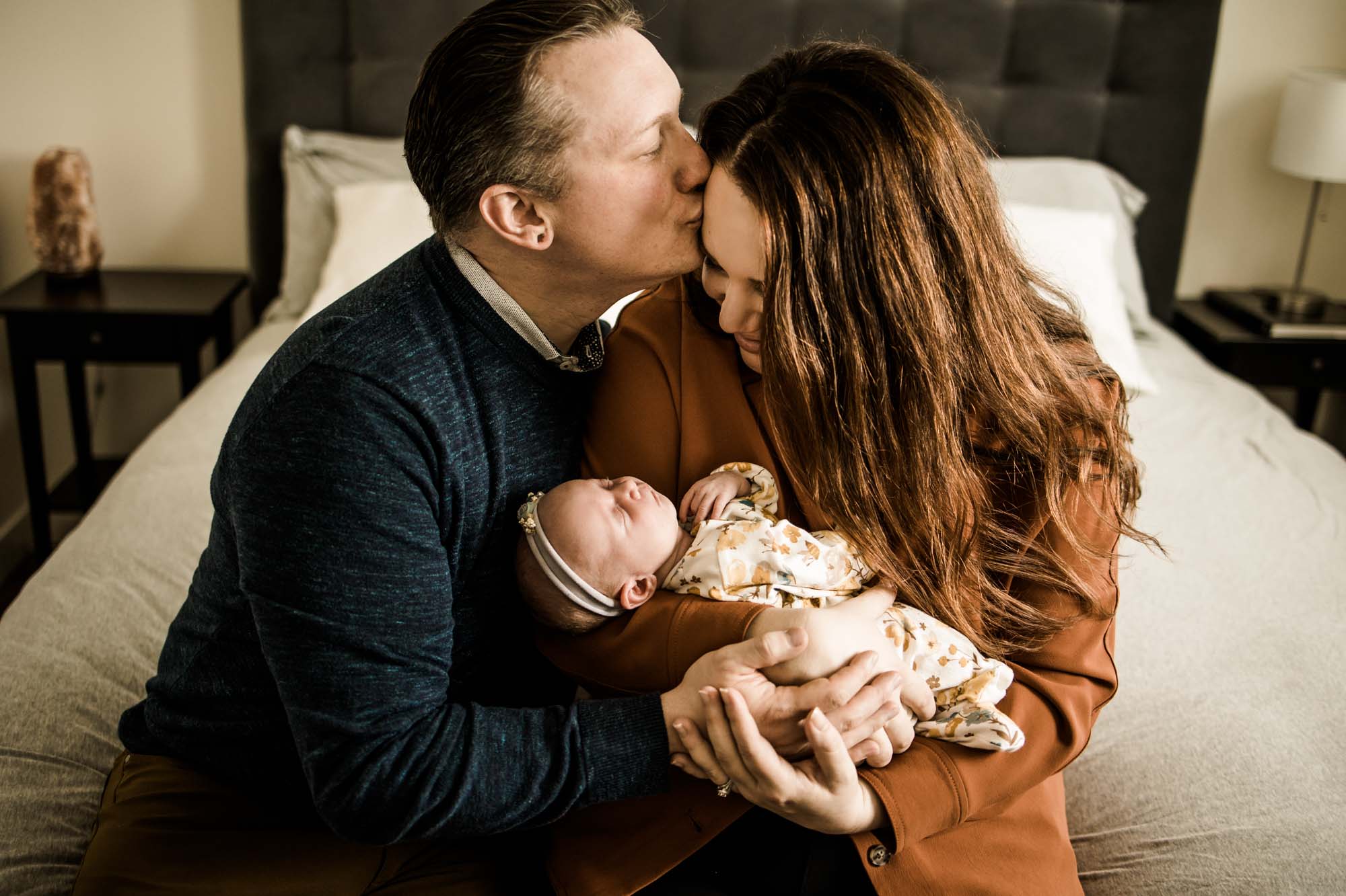 Calgary lifestyle newborn photographer and maternity photographer, baby with her parents during her in-home newborn session