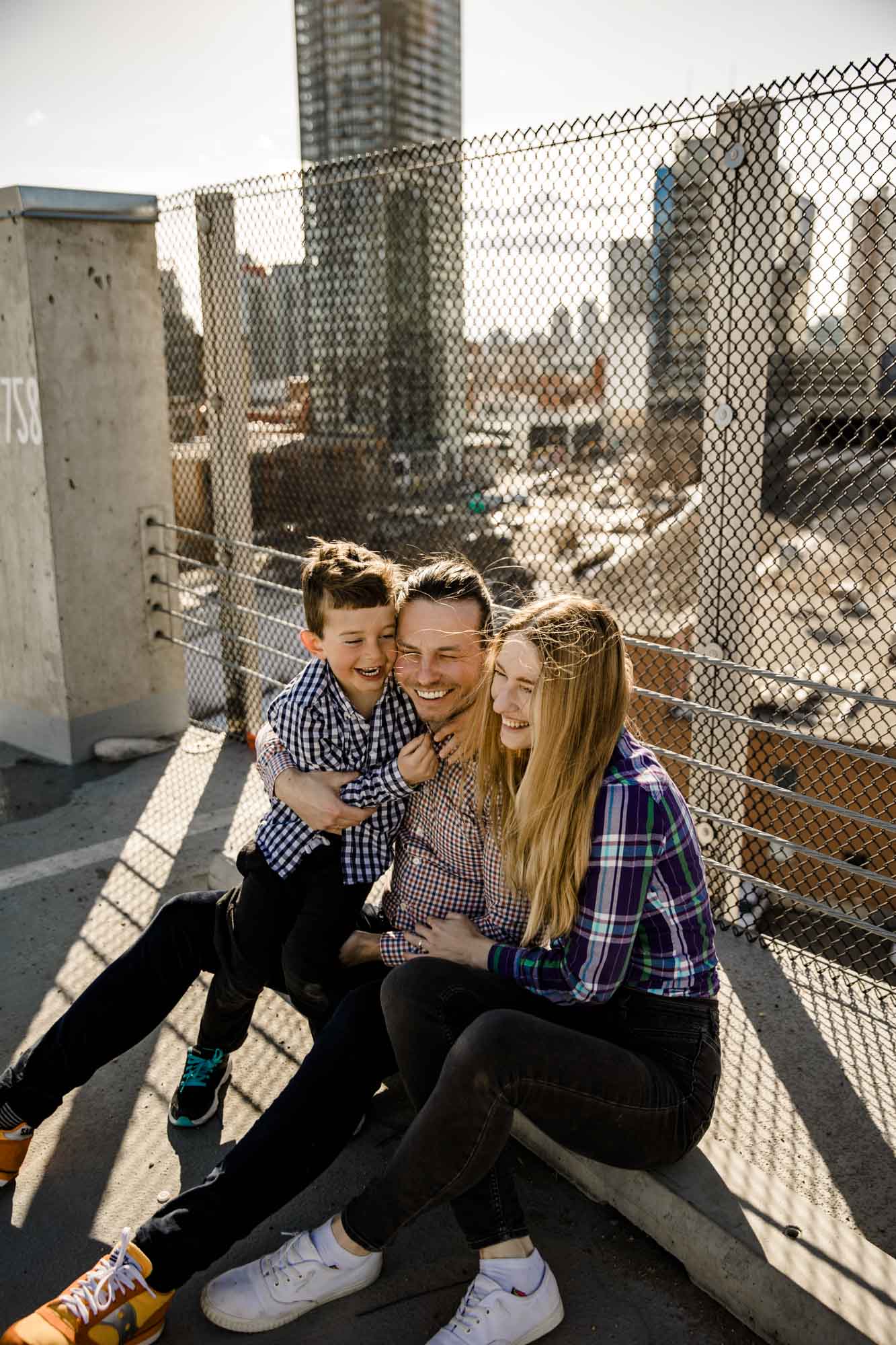 Calgary lifestyle family photograpers, family photo session downtown in the East Village at Platform Innovation Centre in front of the Calgary tower