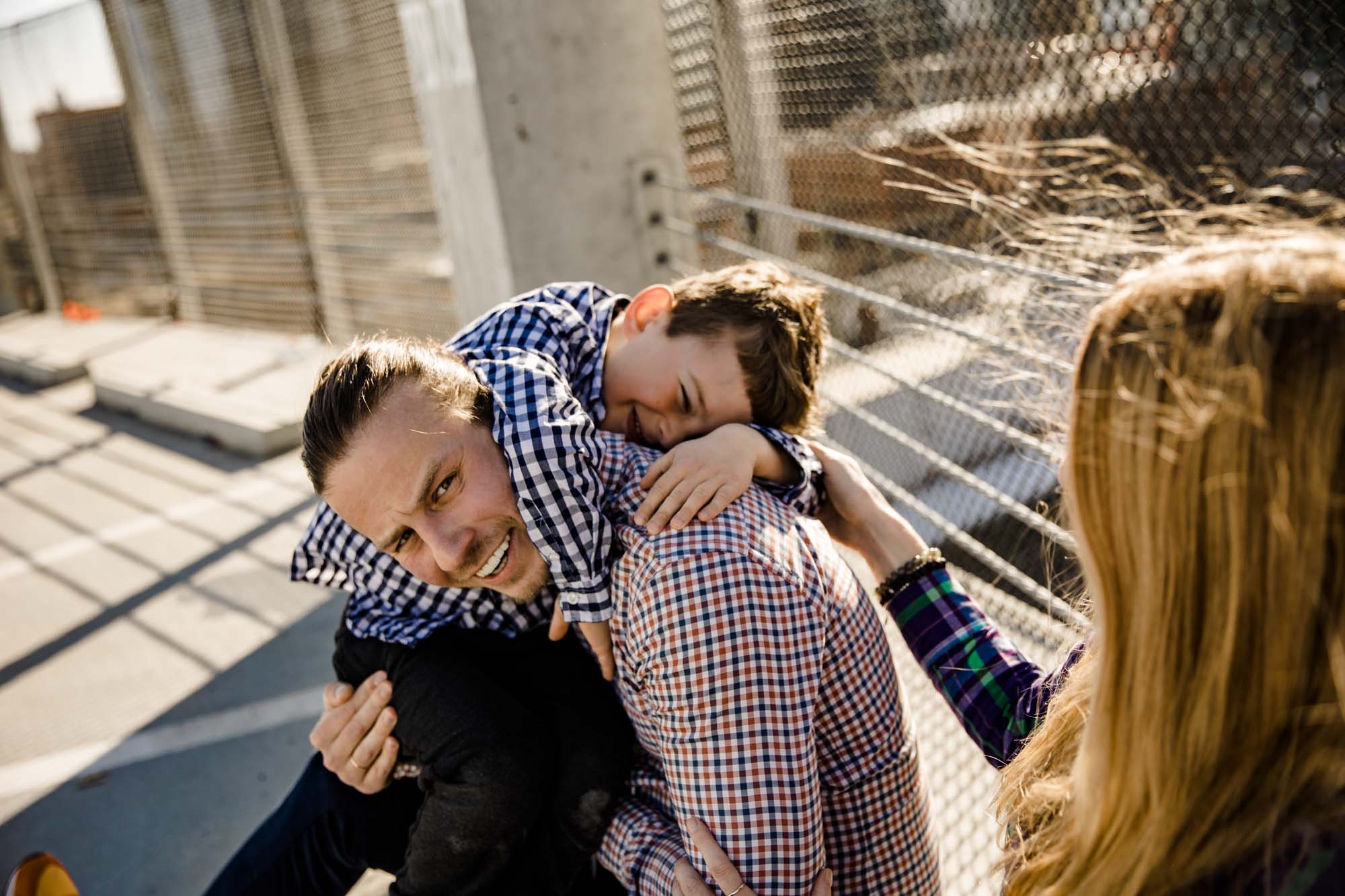 Calgary lifestyle family photograpers, family photo session downtown in the East Village at Platform Innovation Centre in front of the Calgary tower