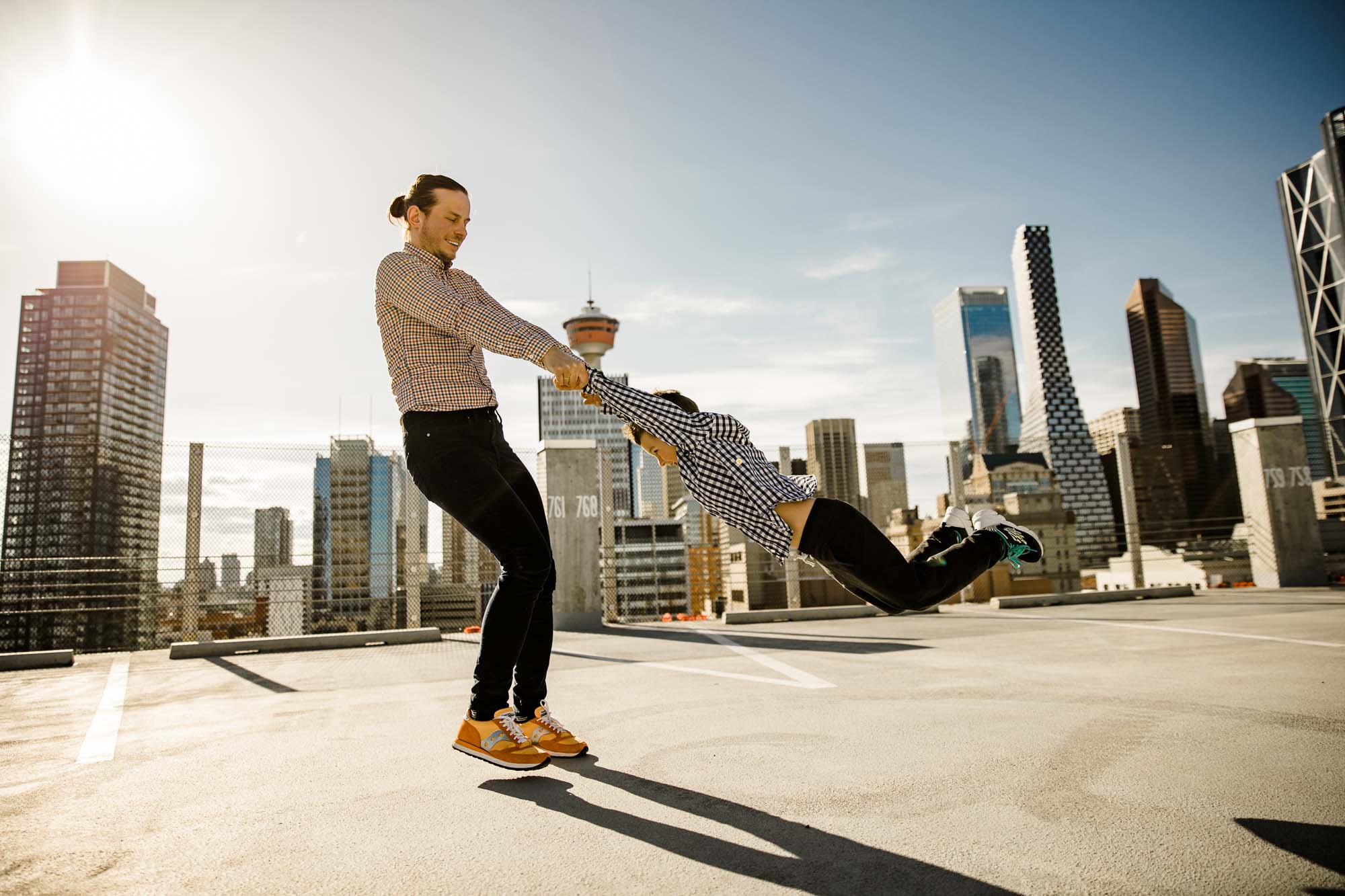 Calgary lifestyle family photograpers, family photo session downtown in the East Village at Platform Innovation Centre in front of the Calgary tower