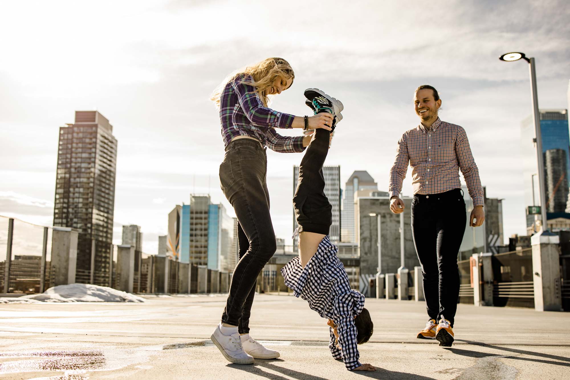 Calgary lifestyle family photograpers, family photo session downtown in the East Village at Platform Innovation Centre in front of the Calgary tower