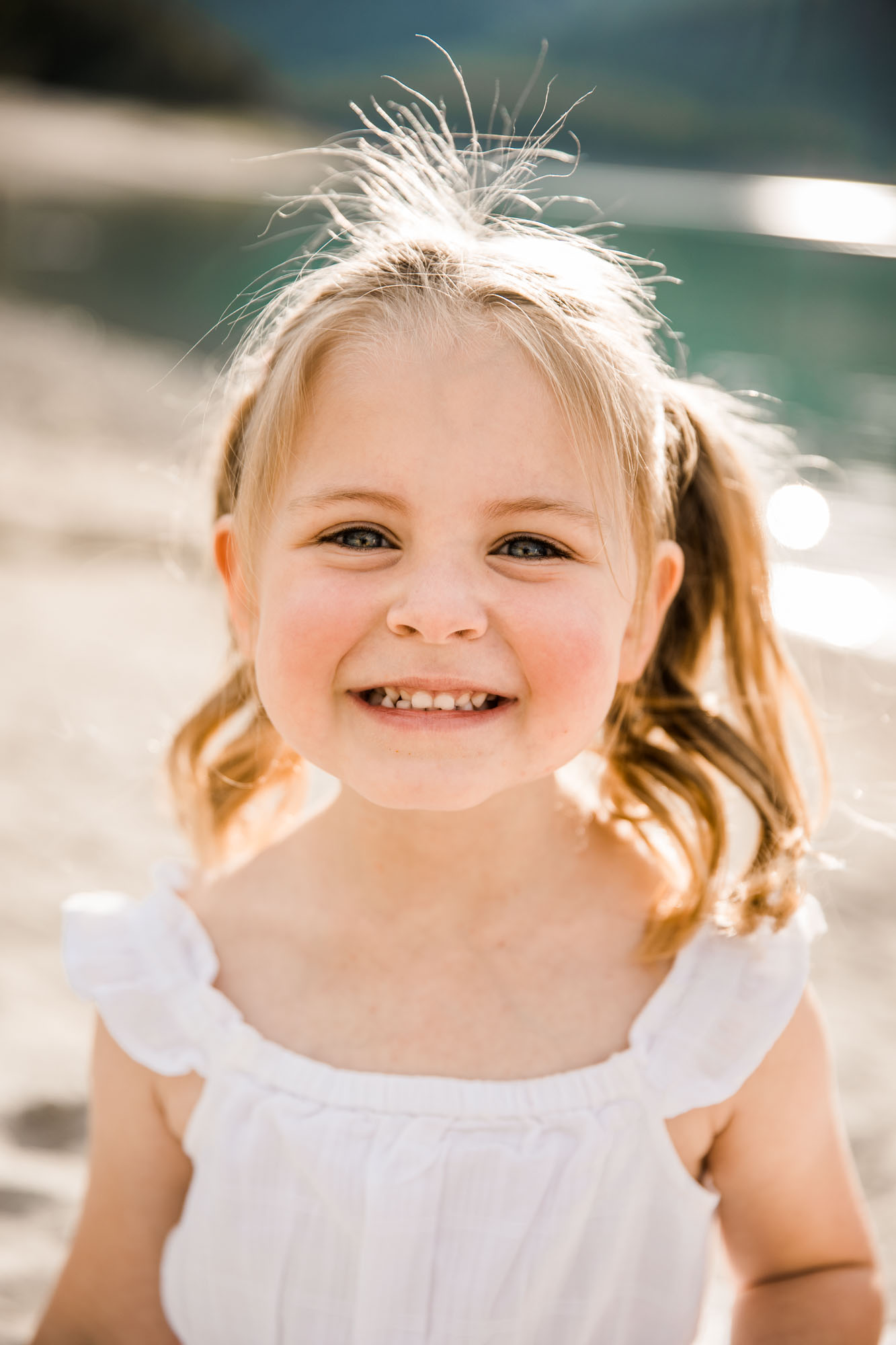 Calgary, Banff, Kananaskis Country lifestyle family photographer, family posing during their beach photoshoot in the mountains in Kananaskis