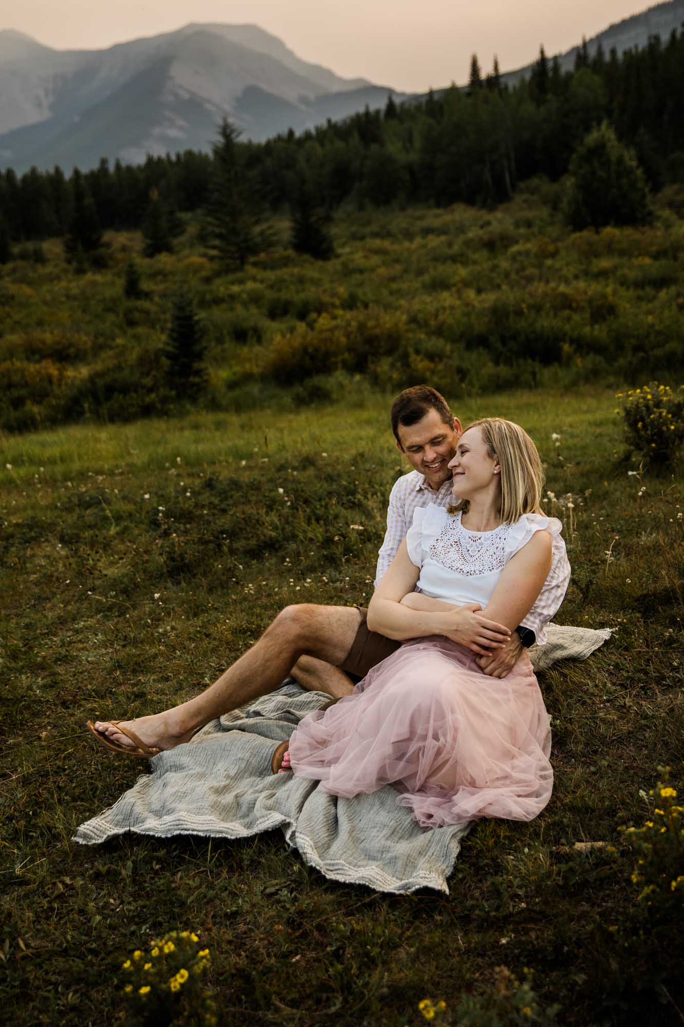 Calgary, Banff and Kananaskis Country lifestyle family photographer, family in front of water and mountains during their photoshoot in Kananaskis Country