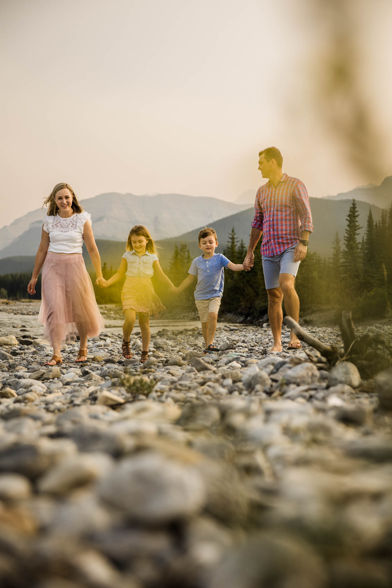 Calgary, Banff and Kananaskis Country lifestyle family photographer, family in front of water and mountains during their photoshoot in Kananaskis Country