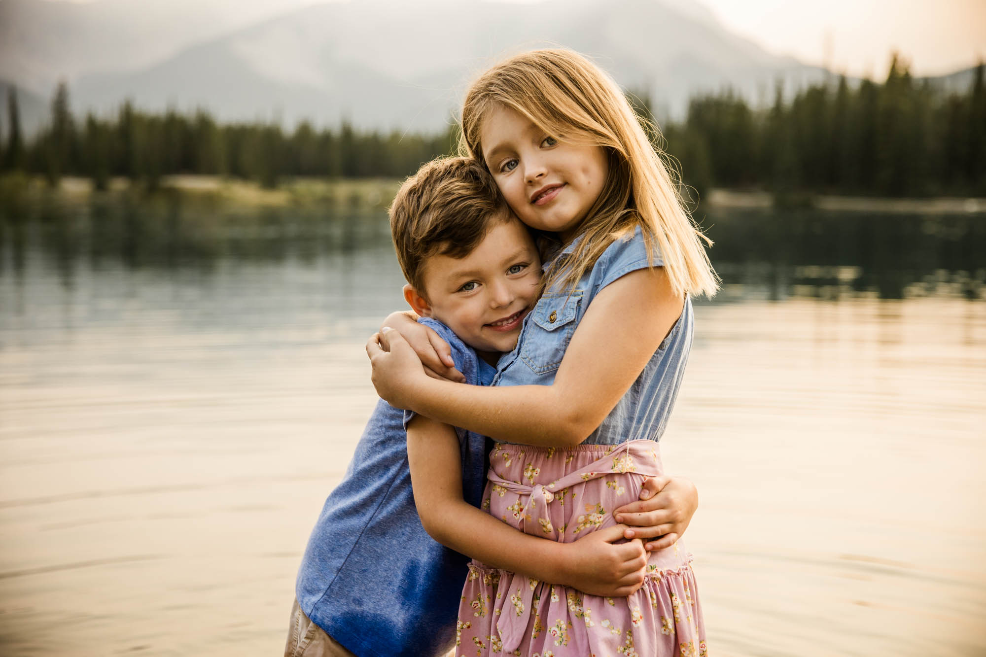 Calgary, Banff and Kananaskis Country lifestyle family photographer, family in front of water and mountains during their photoshoot in Kananaskis Country