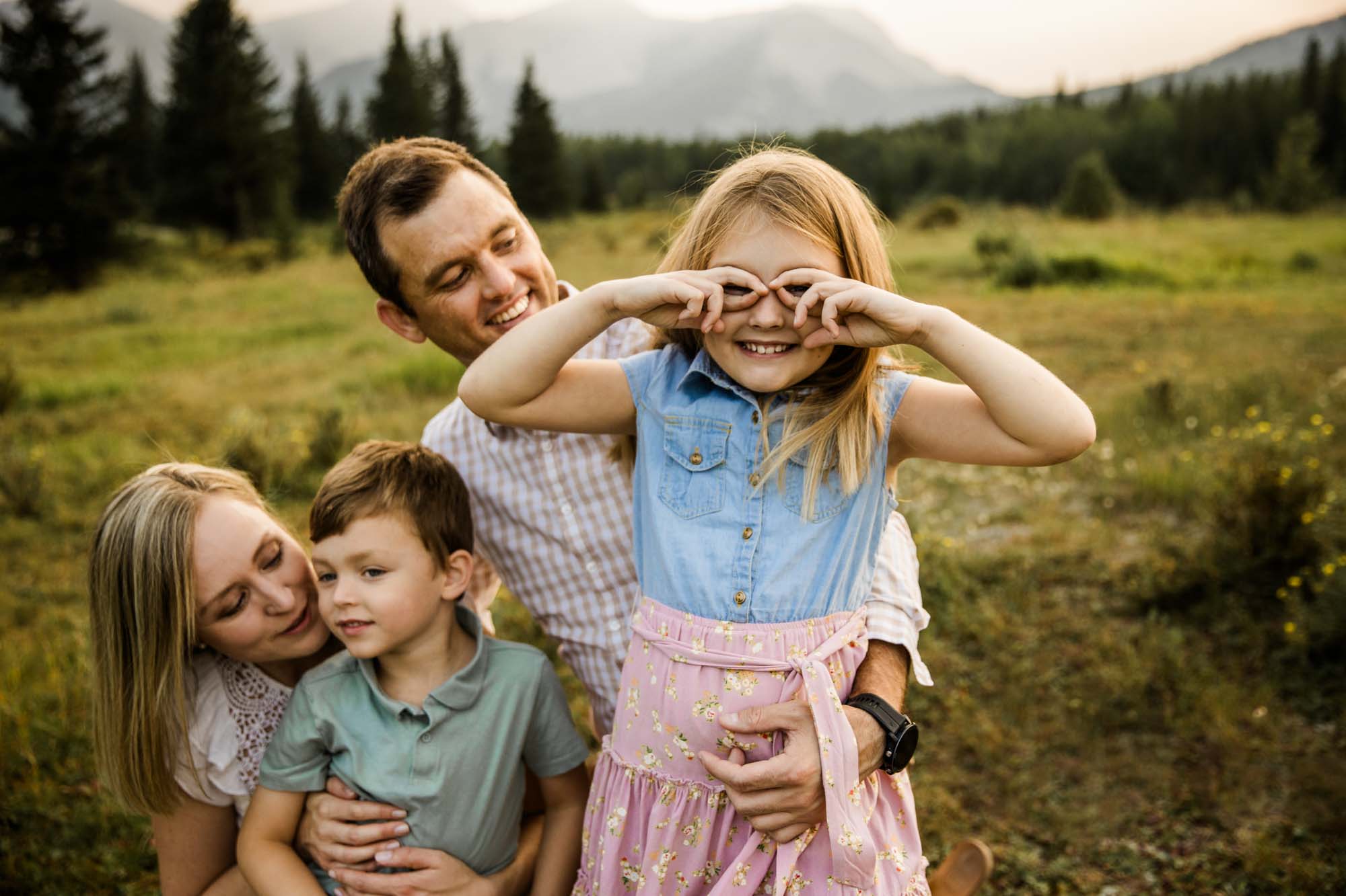 Calgary, Banff and Kananaskis Country lifestyle family photographer, family in front of water and mountains during their photoshoot in Kananaskis Country