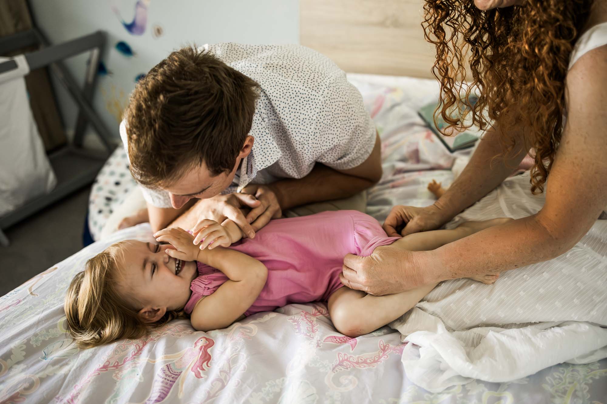 Calgary lifestyle maternity and newborn photographer, family with their newborn baby during their in-home photo session