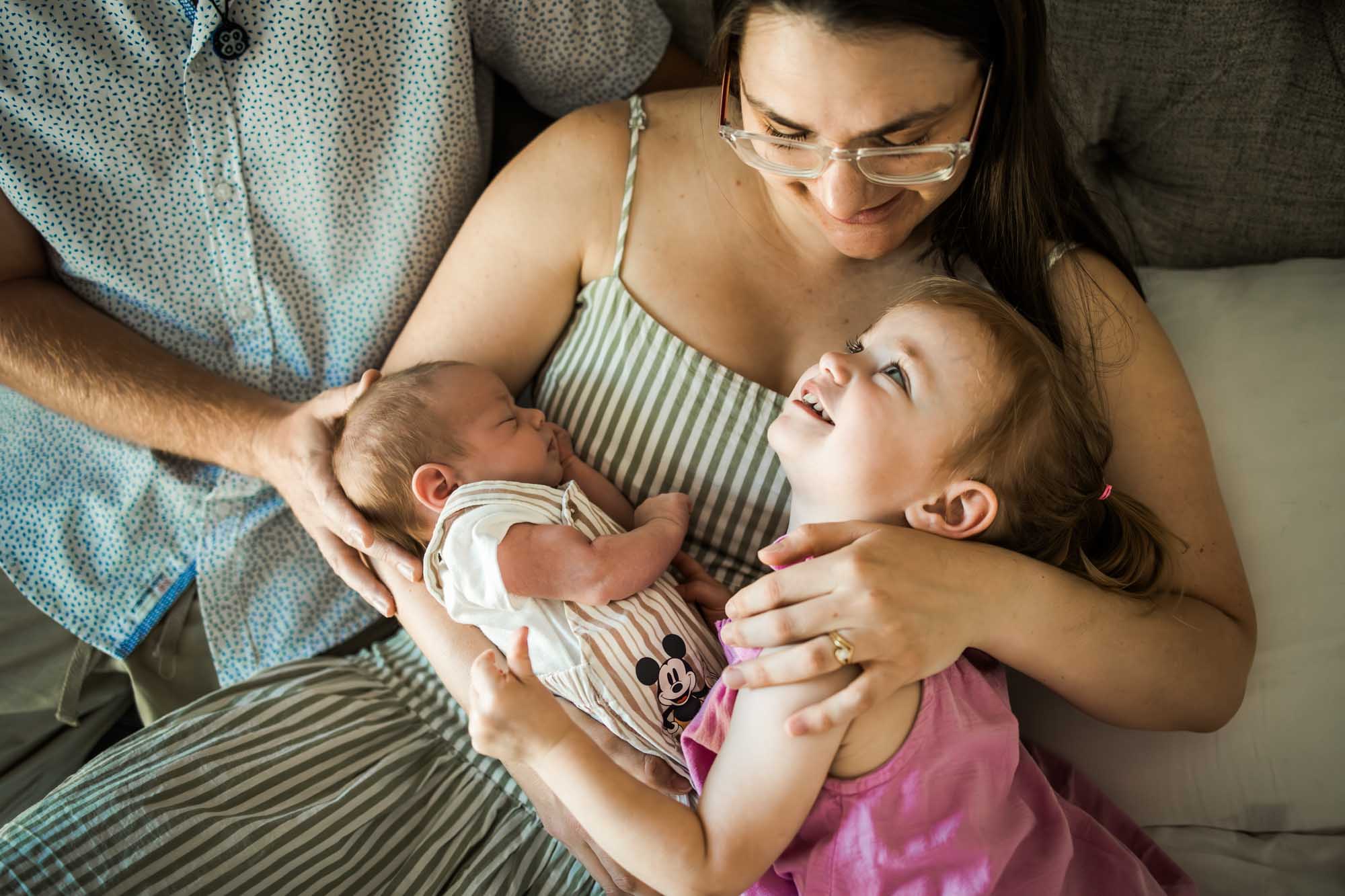 Calgary lifestyle maternity and newborn photographer, family with their newborn baby during their in-home photo session