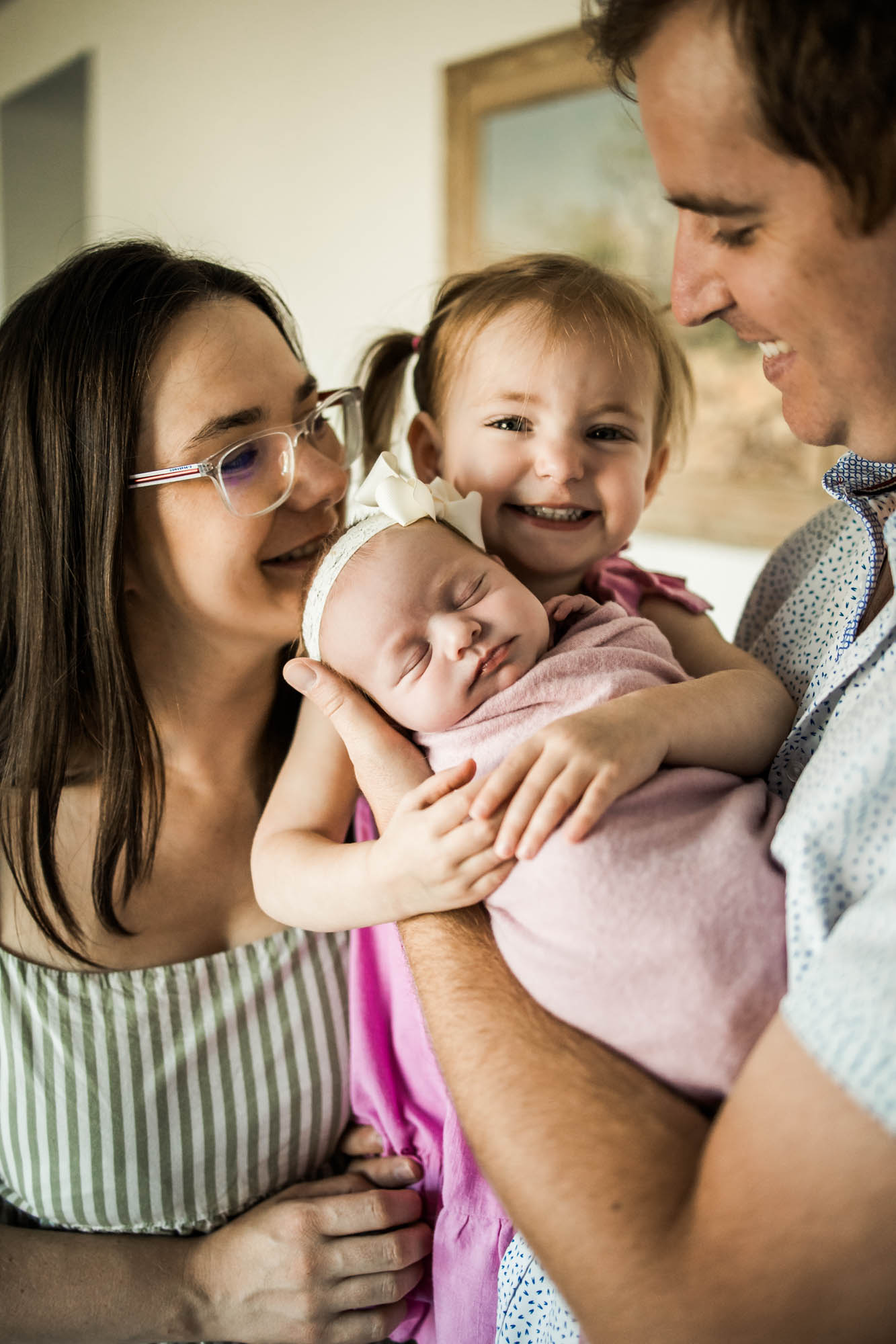 Calgary lifestyle maternity and newborn photographer, family with their newborn baby during their in-home photo session