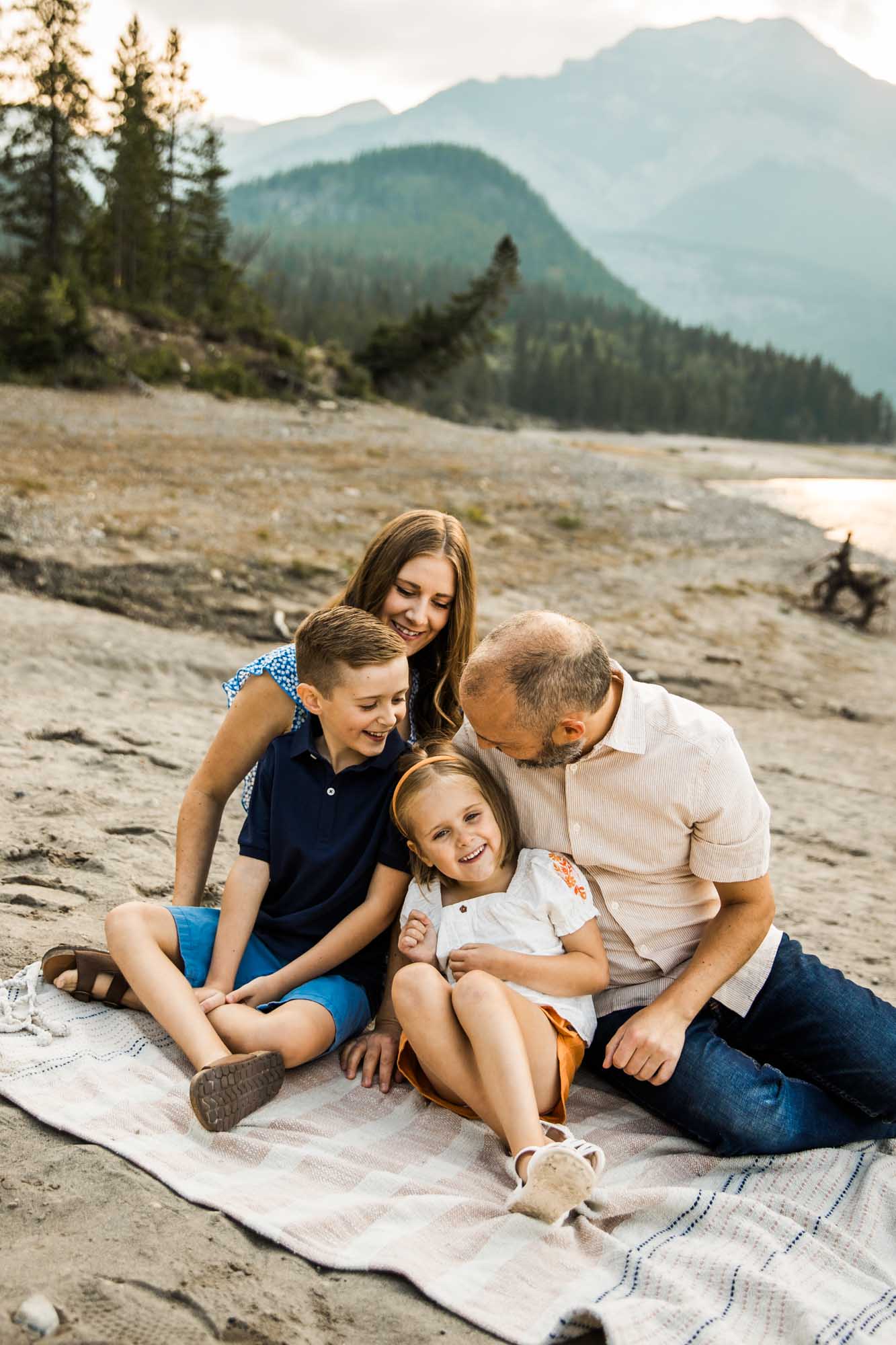 Calgary, Banff, Kananaskis Country lifestyle family photographer, natural and candid photos of a family in front of the mountains at Barrier Lake