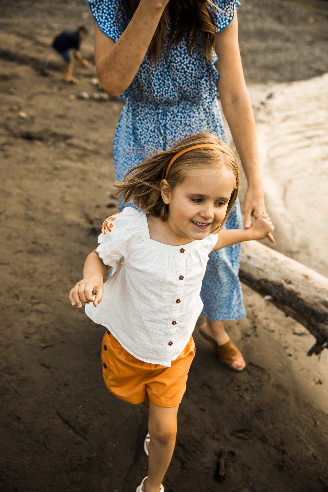 Calgary, Banff, Kananaskis Country lifestyle family photographer, natural and candid photos of a family in front of the mountains at Barrier Lake