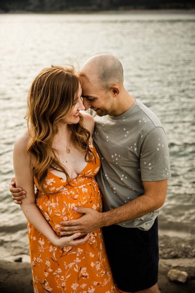 Calgary, Banff, Kananaskis Country maternity, family, newborn photographer, couple in front of the mountains during their maternity photoshoot in Kananaskis Country
