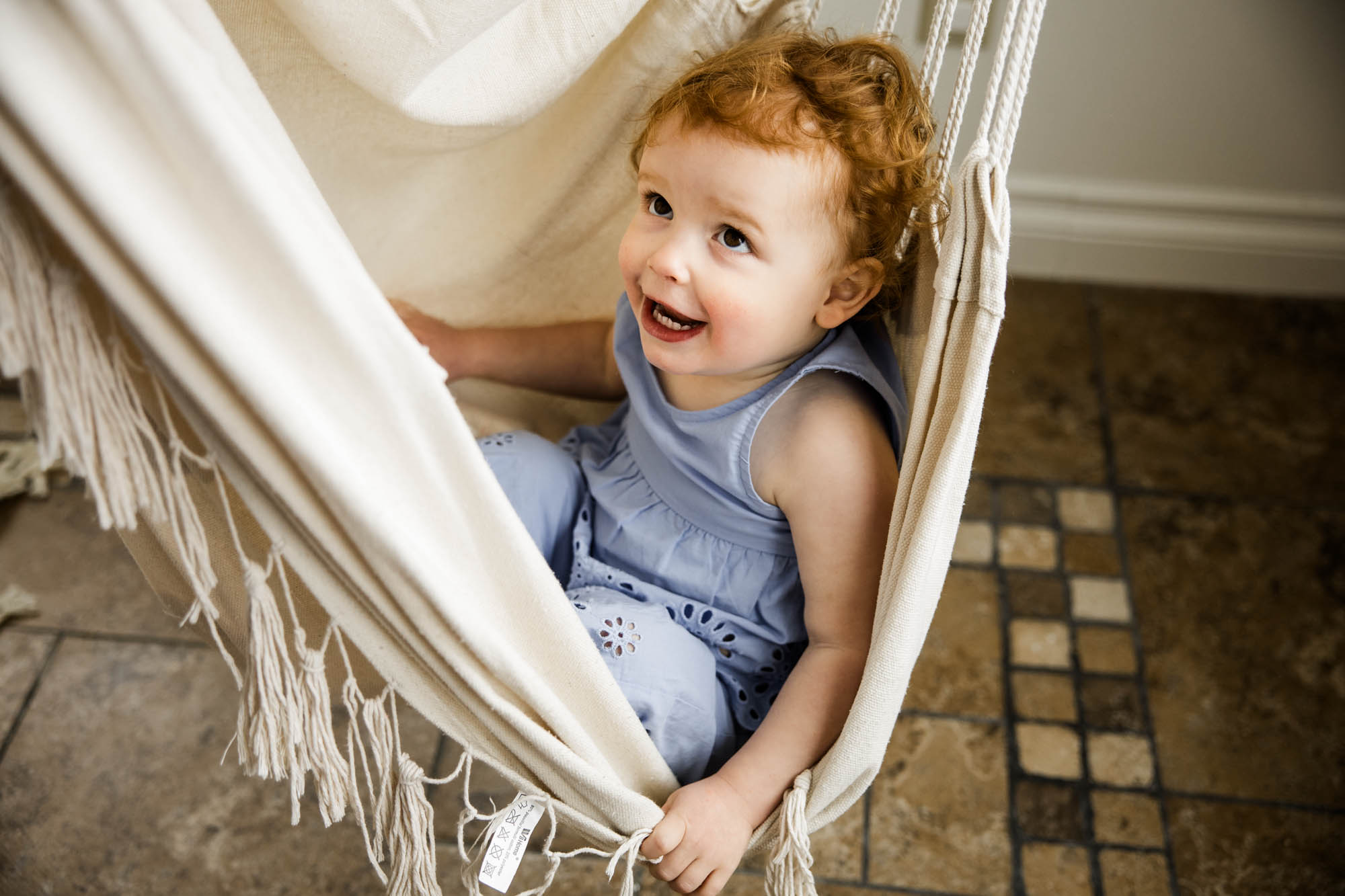 Calgary lifestyle newborn and maternity photographer, family in their home during a newborn photo session with their new baby, lifestyle photos and posed basket photos