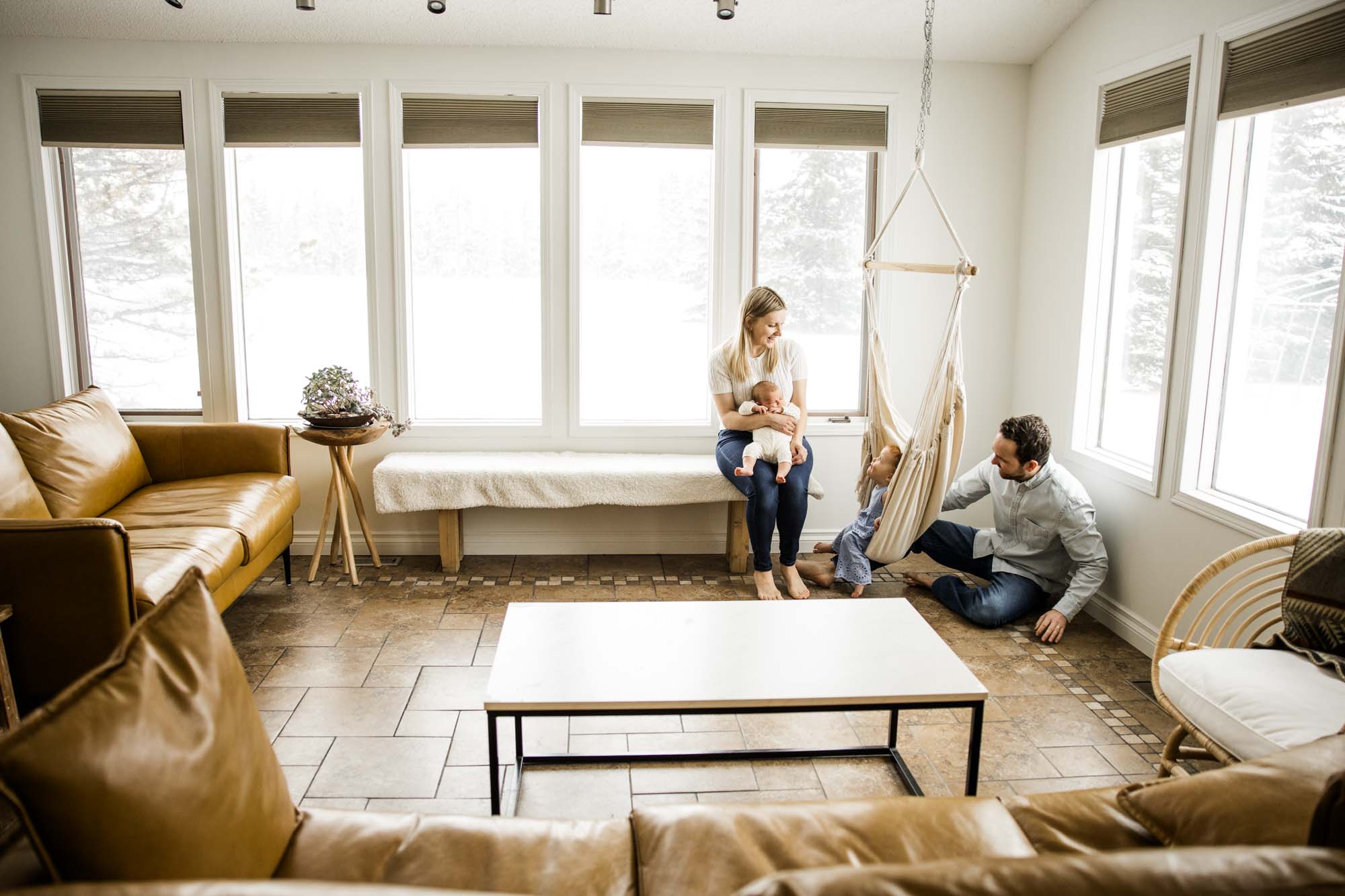 Calgary lifestyle newborn and maternity photographer, family in their home during a newborn photo session with their new baby, lifestyle photos and posed basket photos