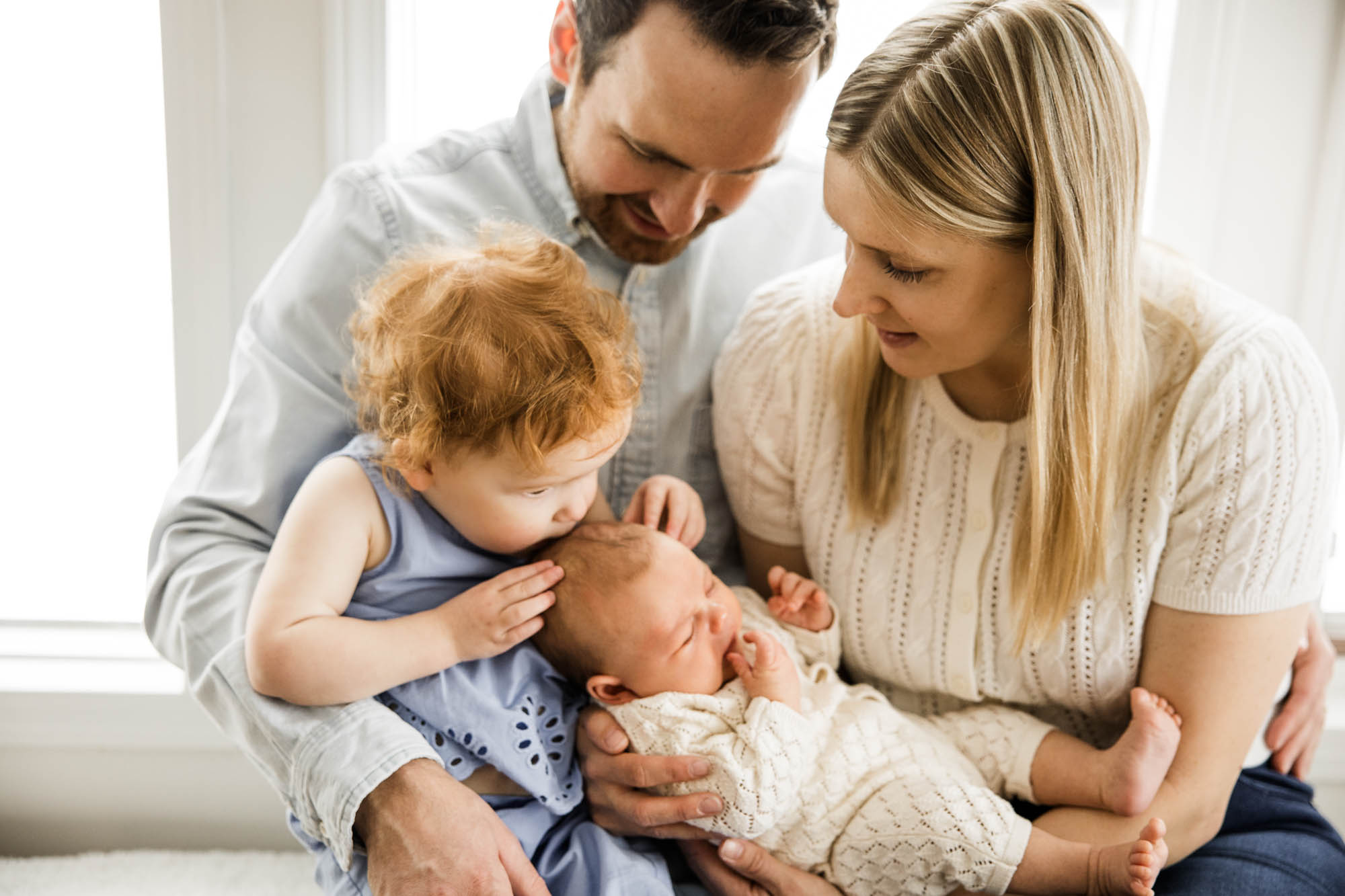 Calgary lifestyle newborn and maternity photographer, family in their home during a newborn photo session with their new baby, lifestyle photos and posed basket photos
