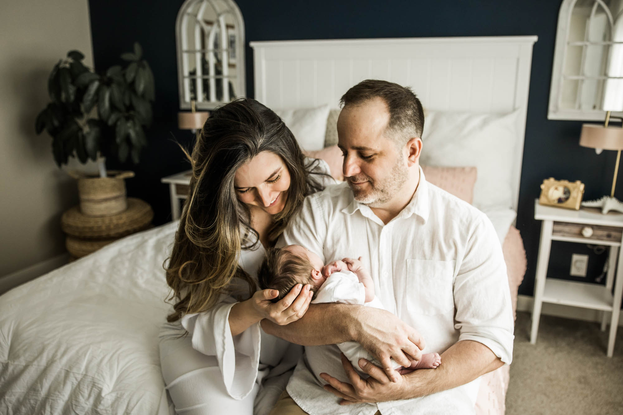 Calgary lifestyle newborn and maternity photographer, family in their home during a newborn photo session with their new baby, lifestyle photos and posed basket photos