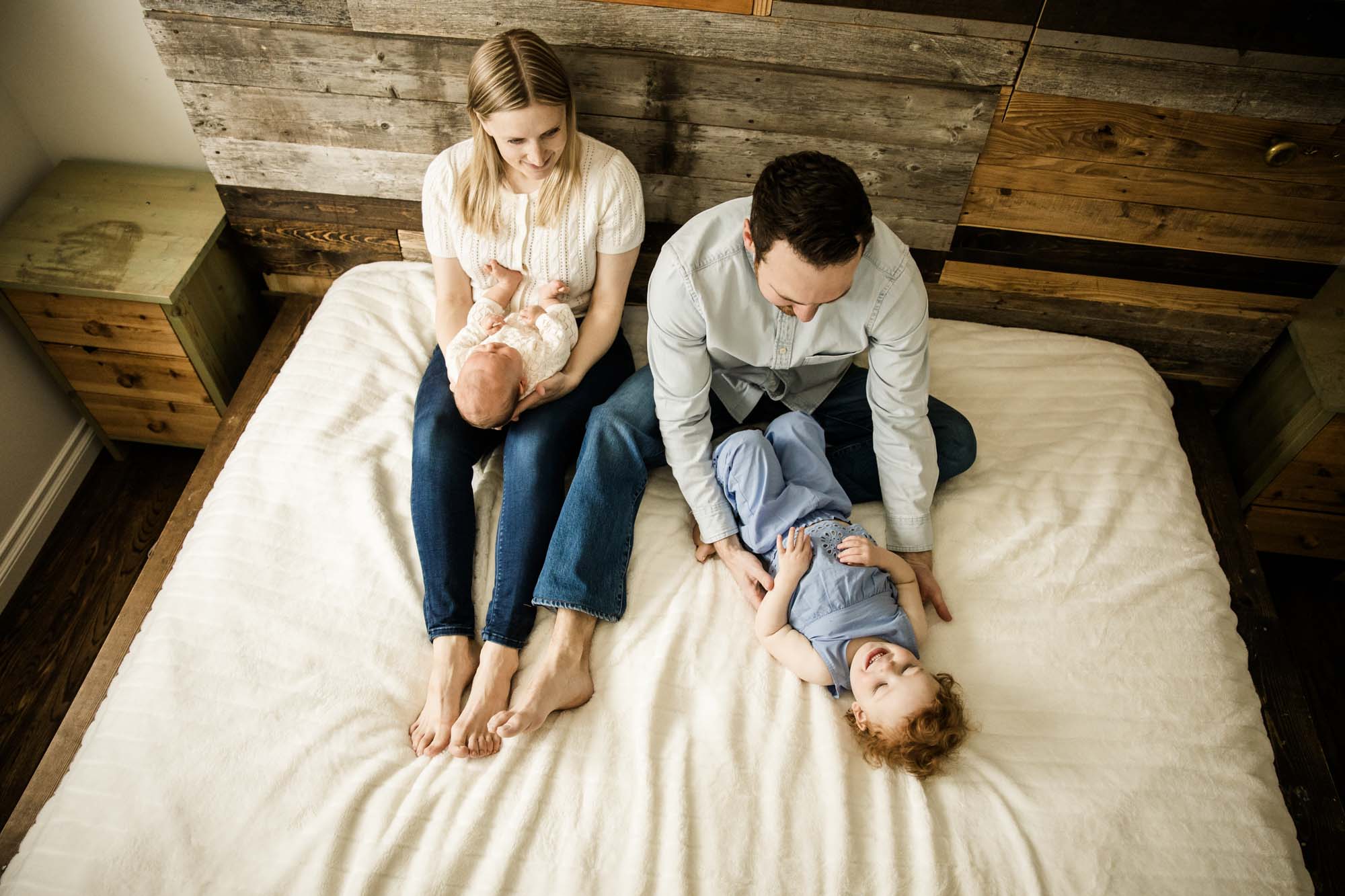 Calgary lifestyle newborn and maternity photographer, family in their home during a newborn photo session with their new baby, lifestyle photos and posed basket photos