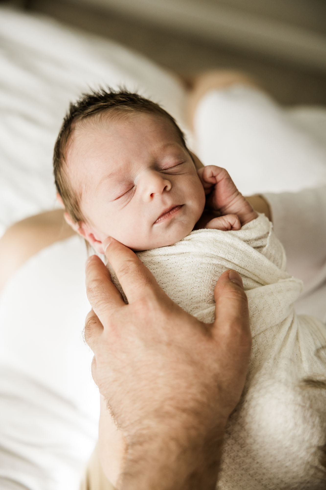 Calgary lifestyle newborn and maternity photographer, family in their home during a newborn photo session with their new baby, lifestyle photos and posed basket photos