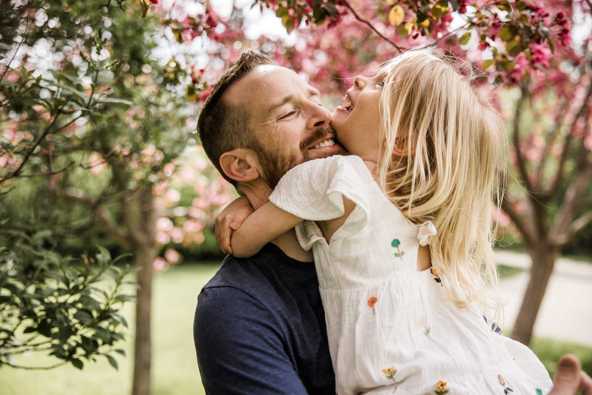 Calgary family photographer, family during their mini session at Baker Park around the cherry blossom trees
