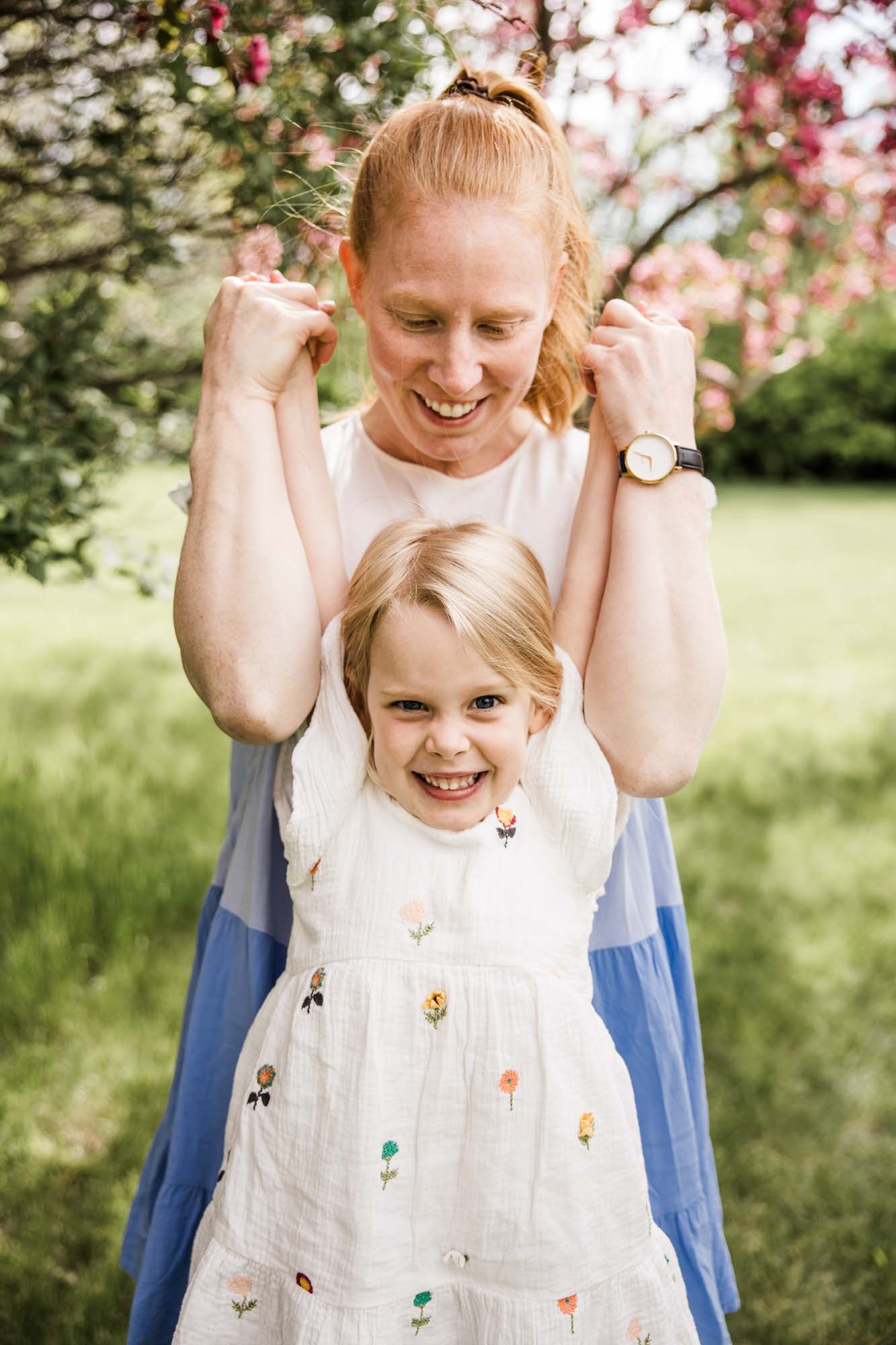 Calgary family photographer, family during their mini session at Baker Park around the cherry blossom trees