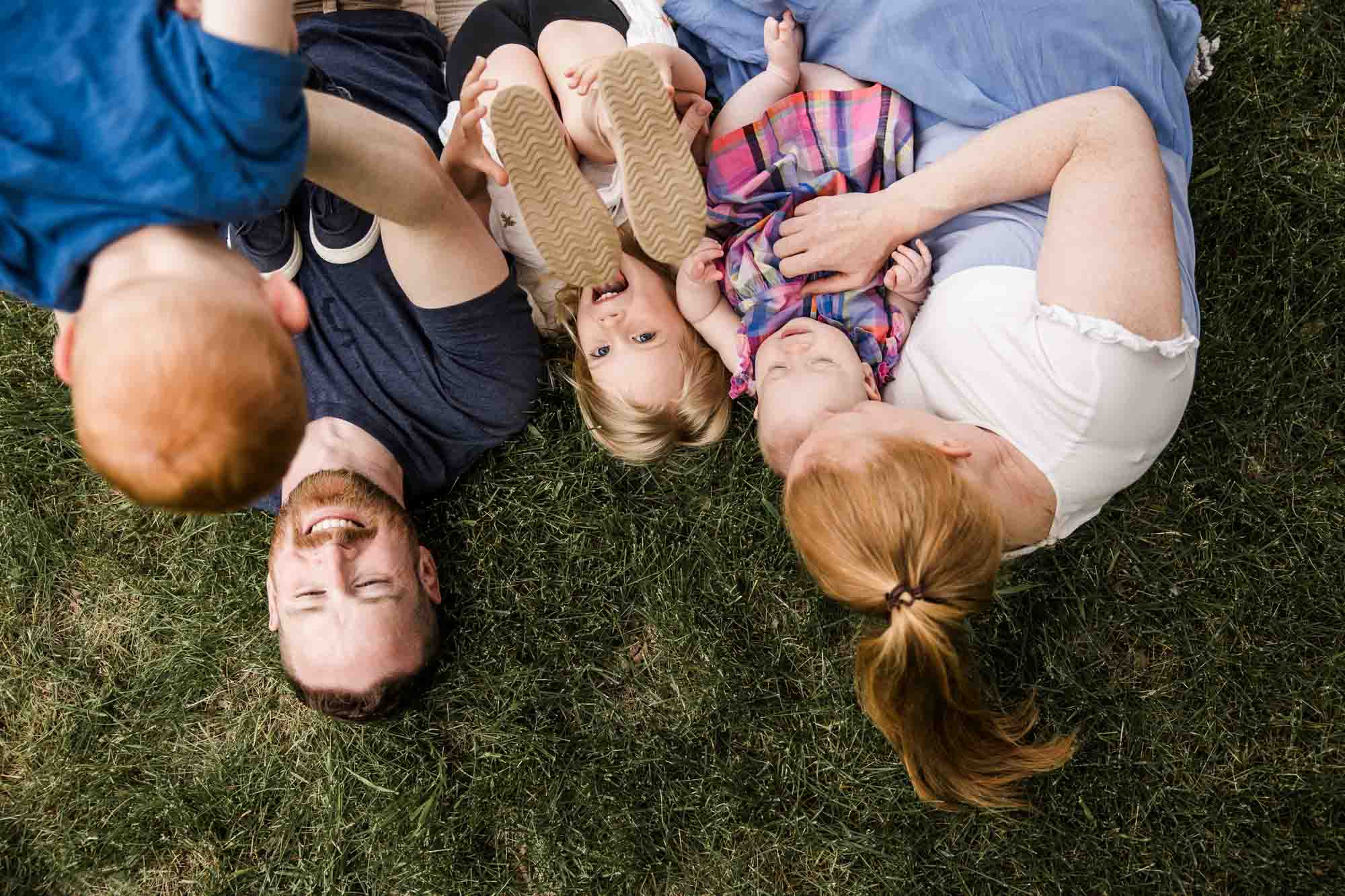 Calgary family photographer, family during their mini session at Baker Park around the cherry blossom trees