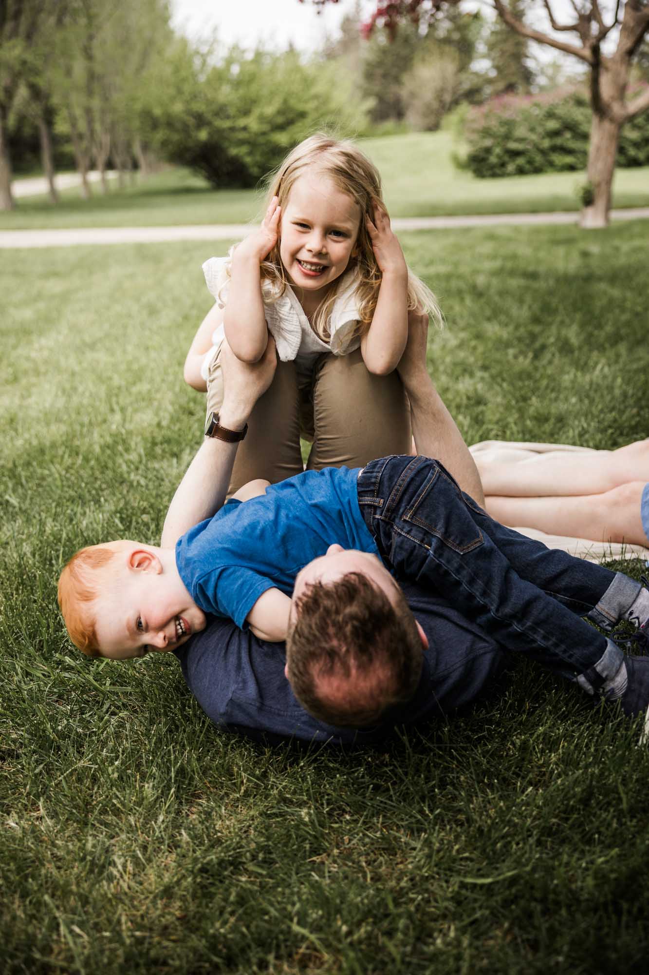 Calgary family photographer, family during their mini session at Baker Park around the cherry blossom trees