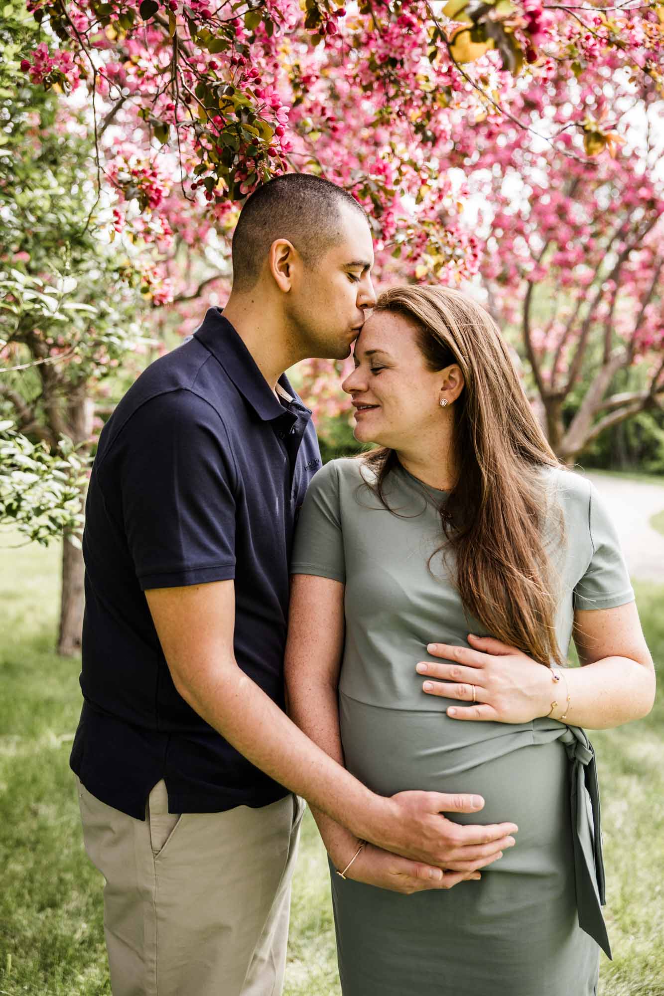 Calgary family photographer, family during their mini session at Baker Park around the cherry blossom trees