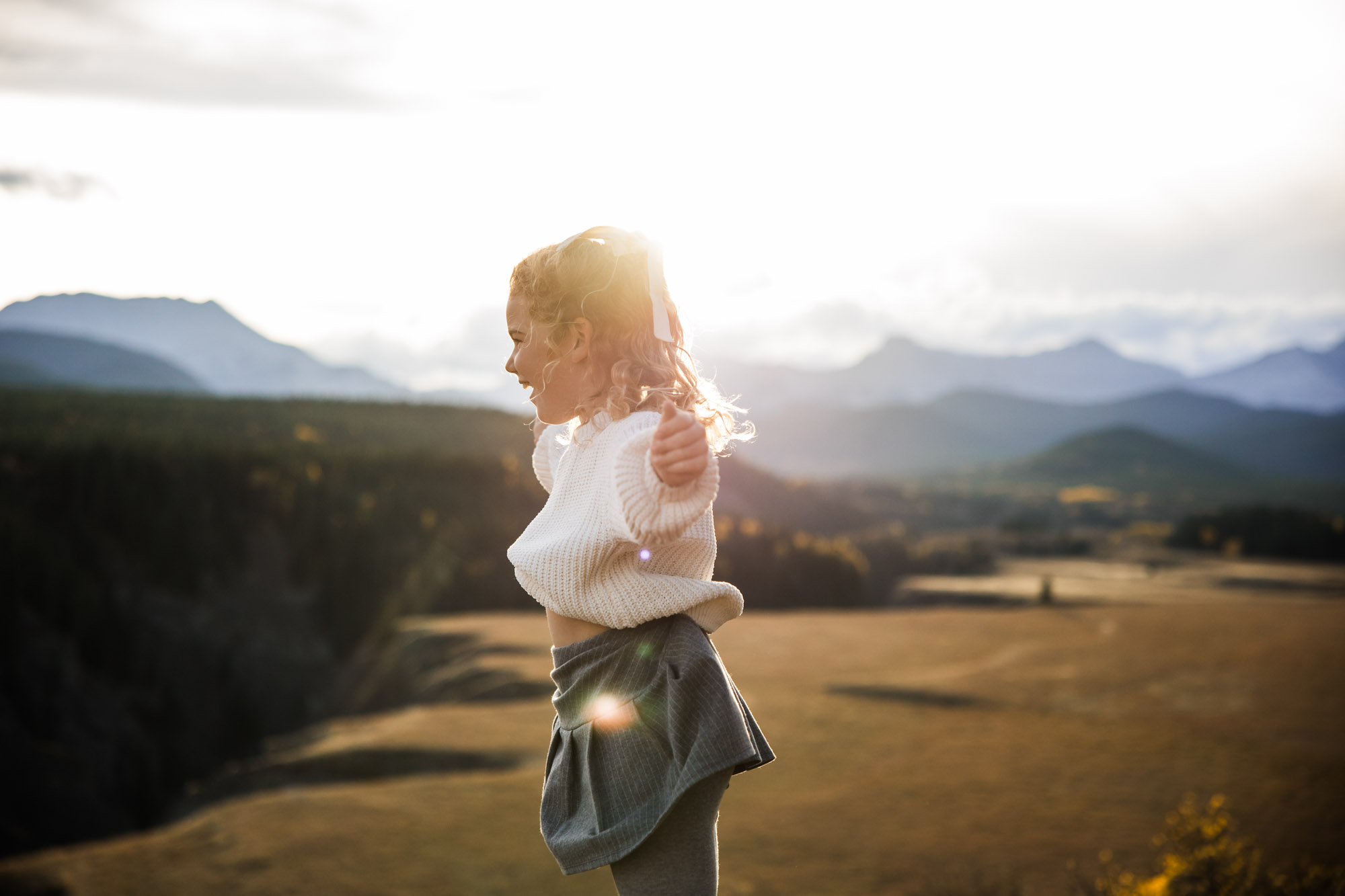 Calgary, Banff, Canmore, Kananaskis lifestyle family photographer, family in the mountains at sunset suring their photoshoot, with real candid documentary style