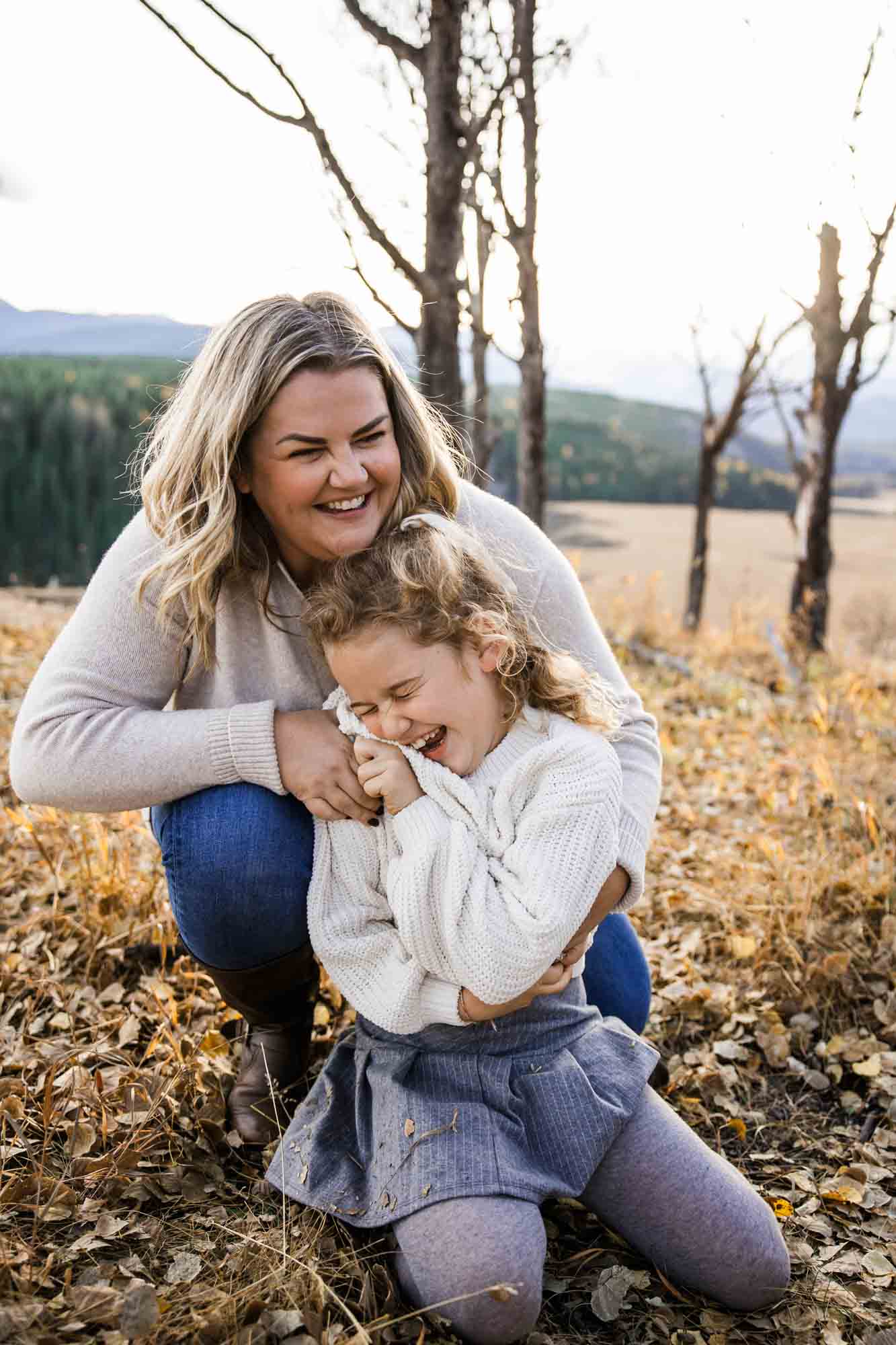 Calgary, Banff, Canmore, Kananaskis lifestyle family photographer, family in the mountains at sunset suring their photoshoot, with real candid documentary style