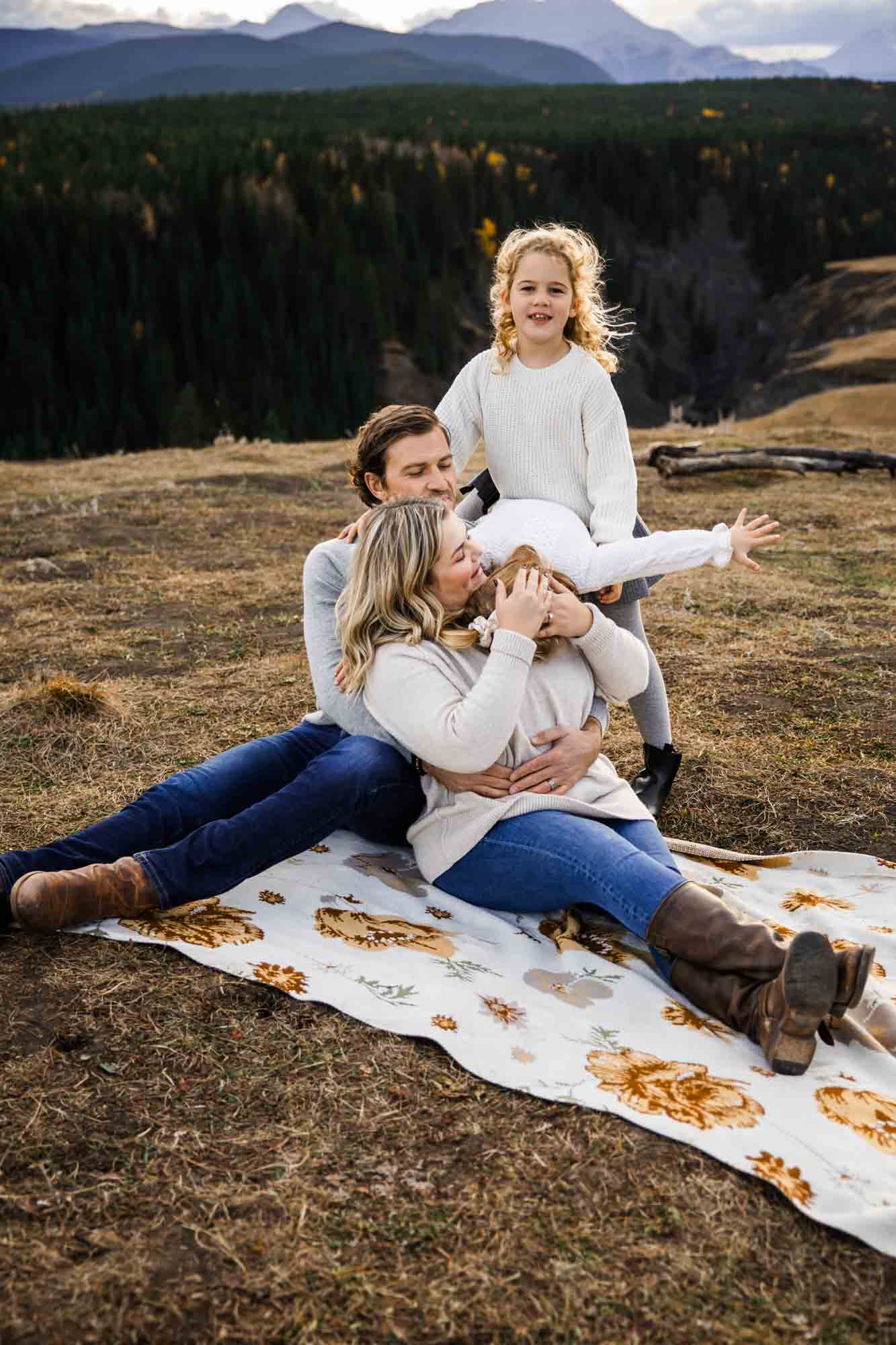 Calgary, Banff, Canmore, Kananaskis lifestyle family photographer, family in the mountains at sunset suring their photoshoot, with real candid documentary style