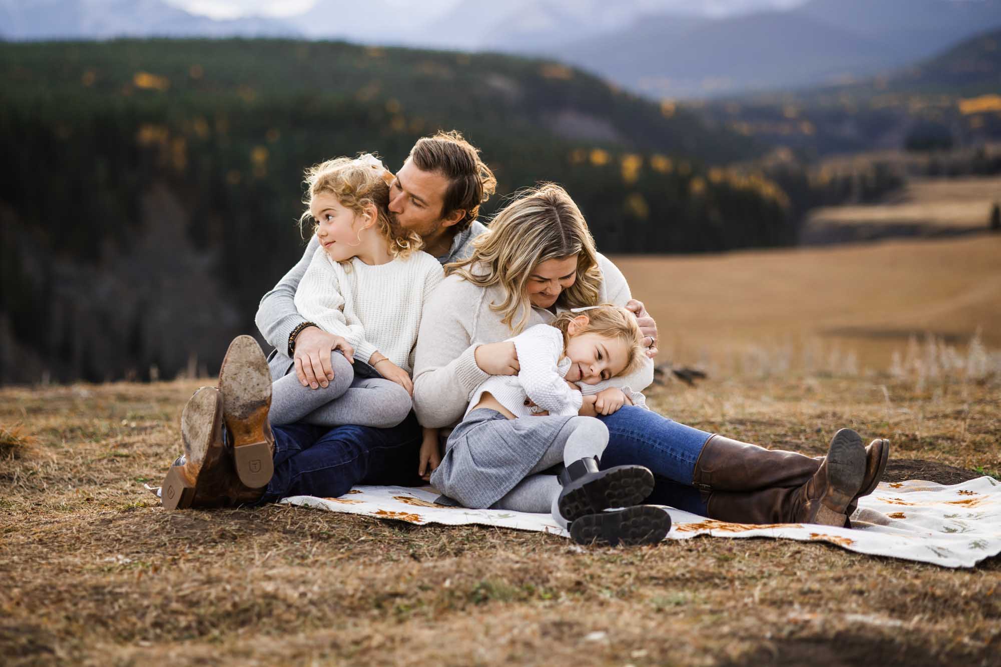 Calgary, Banff, Canmore, Kananaskis lifestyle family photographer, family in the mountains at sunset suring their photoshoot, with real candid documentary style