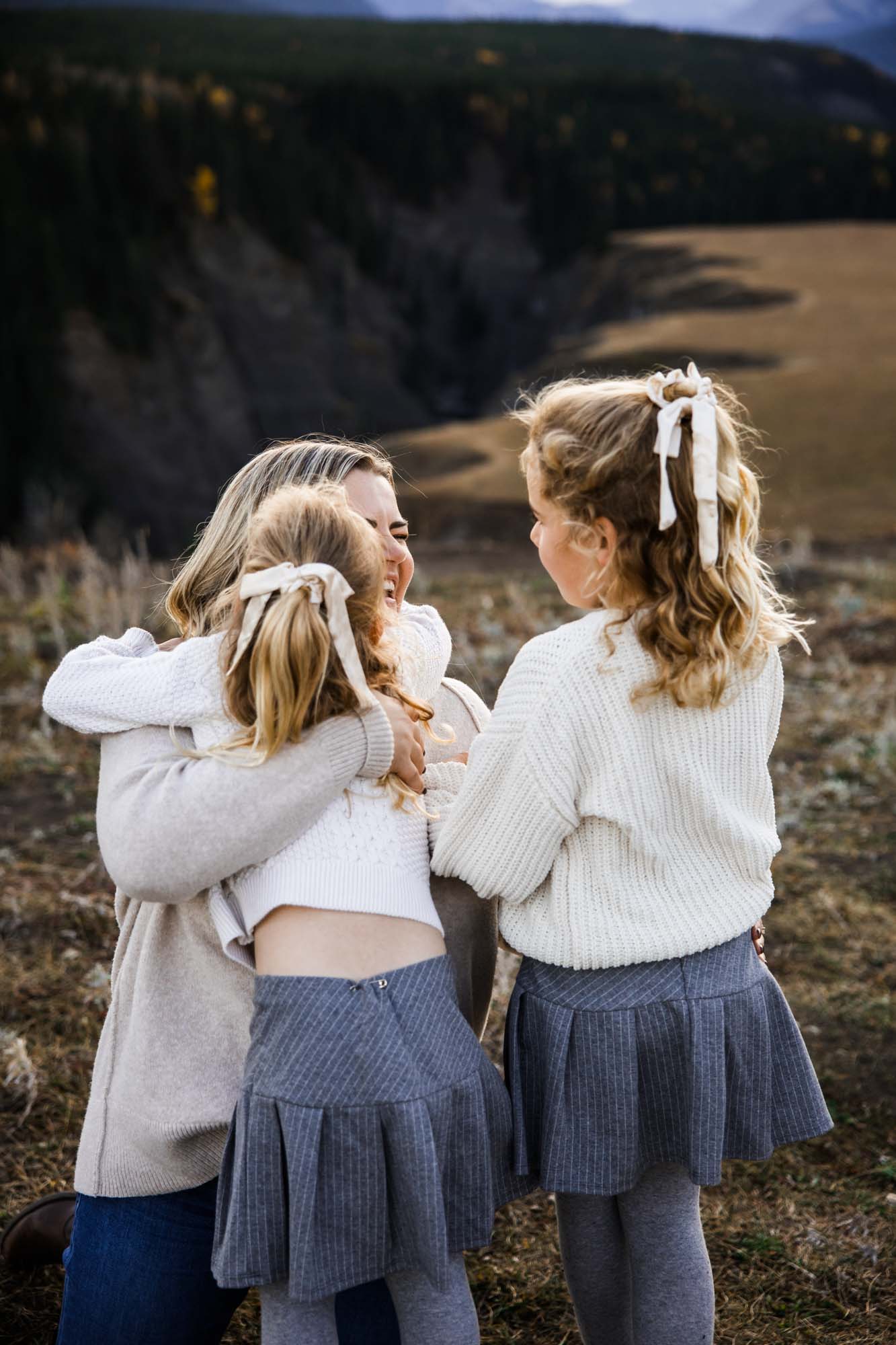 Calgary, Banff, Canmore, Kananaskis lifestyle family photographer, family in the mountains at sunset suring their photoshoot, with real candid documentary style