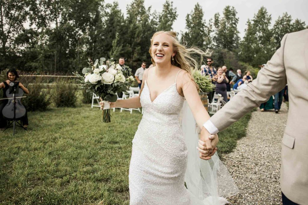 Calgary wedding photographer, bride and groom on their wedding day at Cork and Crate Estates in Olds Alberta, storytelling, candid, warm, editorial wedding photography