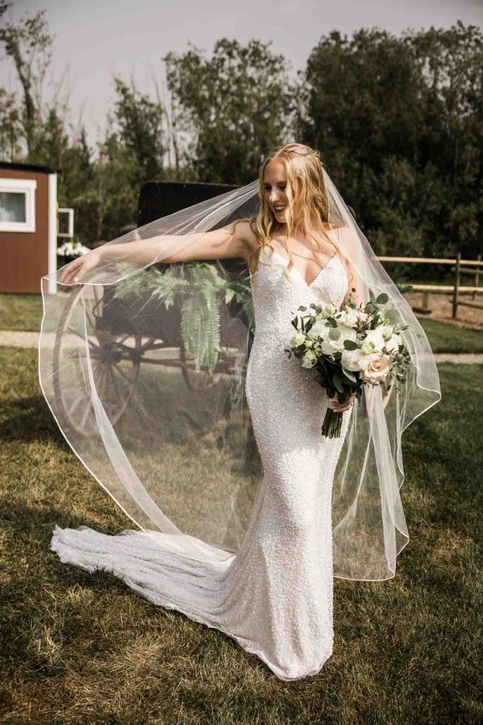 Calgary wedding photographer, bride and groom on their wedding day at Cork and Crate Estates in Olds Alberta, storytelling, candid, warm, editorial wedding photography