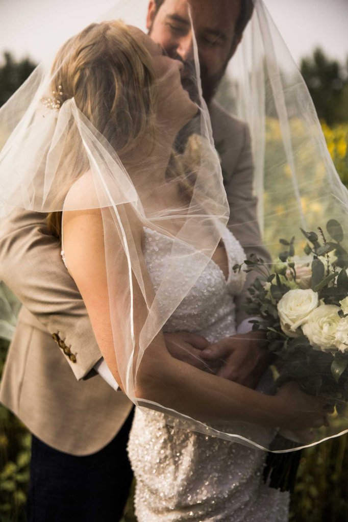 Calgary wedding photographer, bride and groom on their wedding day at Cork and Crate Estates in Olds Alberta, storytelling, candid, warm, editorial wedding photography
