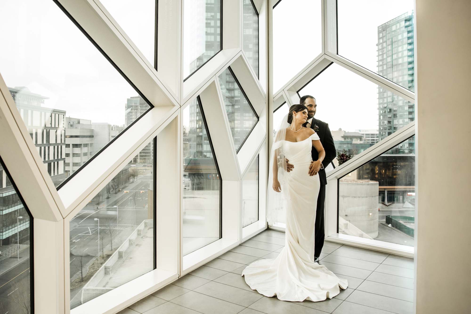 Calgary wedding photographer, bride and groom on their wedding day at the Central Library, candid, documentary, storytelling photography
