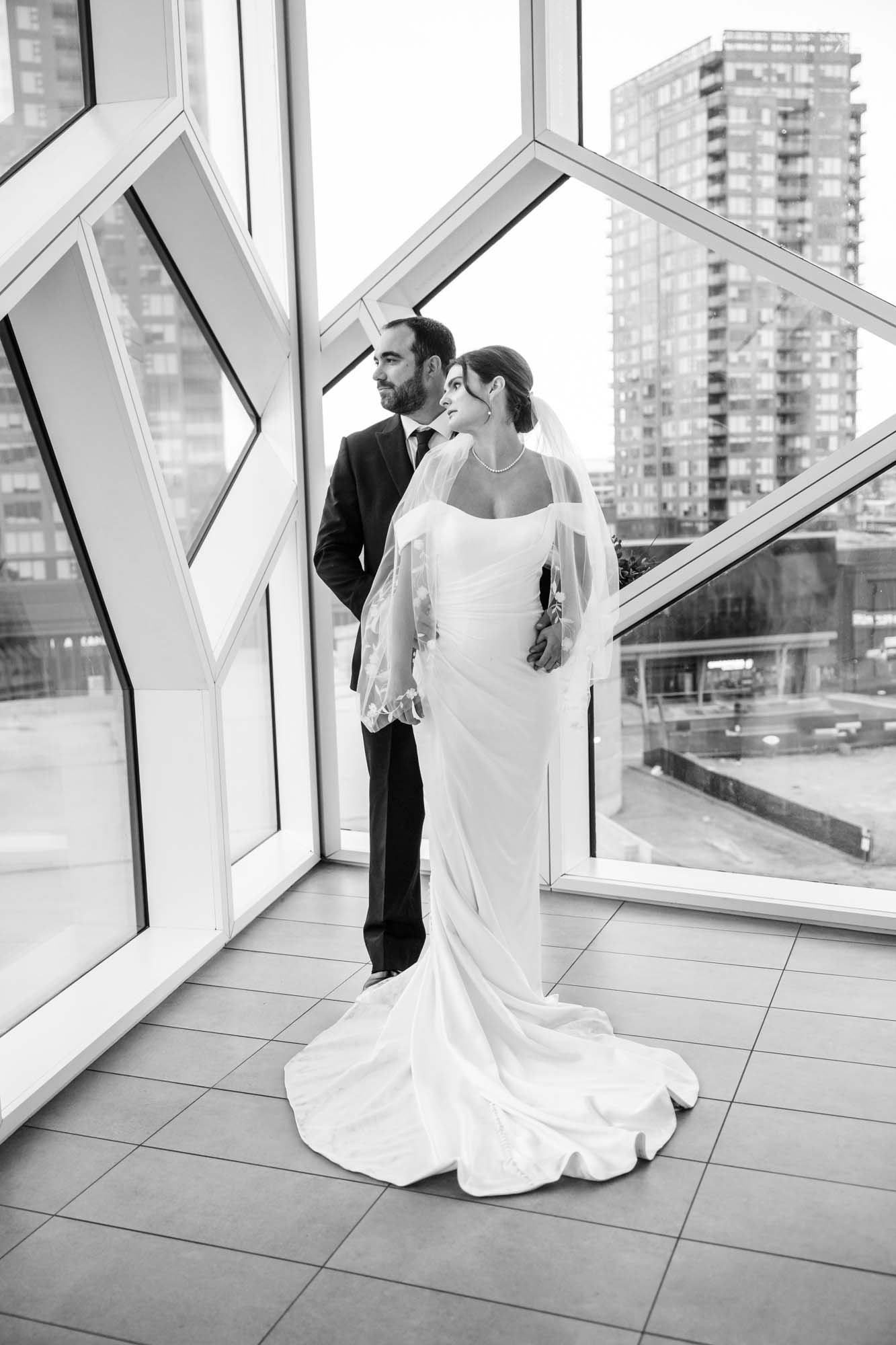 Calgary wedding photographer, bride and groom on their wedding day at the Central Library, candid, documentary, storytelling photography